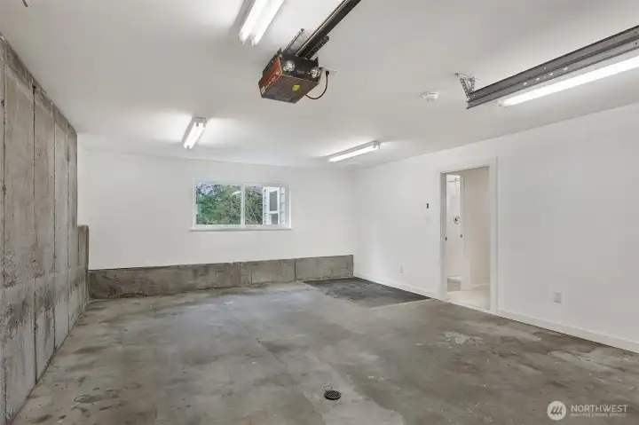 The extra wide 1-car garage is equipped with new or newer insulation (in ceiling and house wall), drywall, garage door, and EV charging!