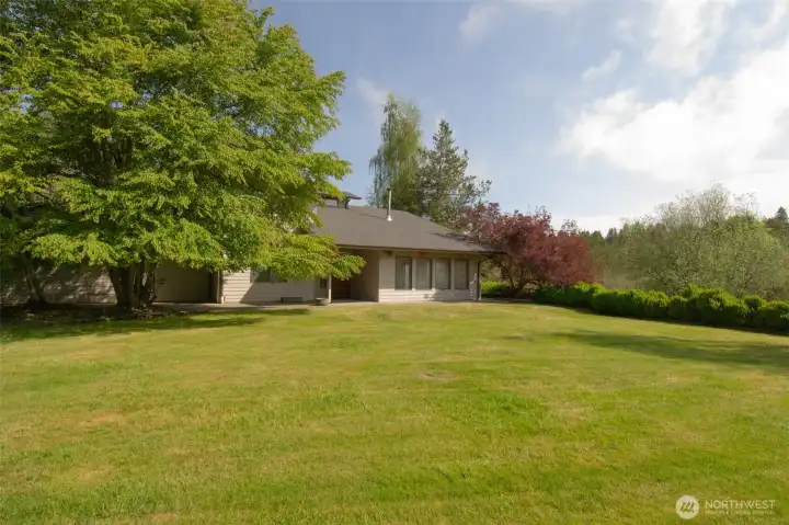 Large level front lawn features a terraced area