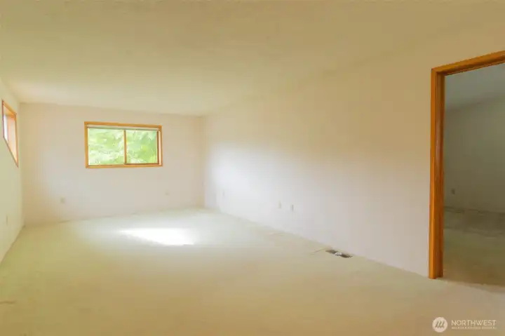 Huge primary bedroom upstairs is bright and spacious.