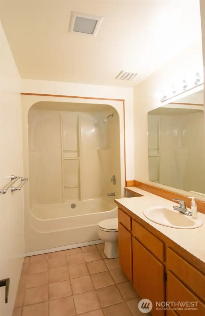 Full downstair bathroom with tile floor.