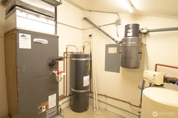Mechanical room with electric air handler, water heater, water treatment and built in vacuum.