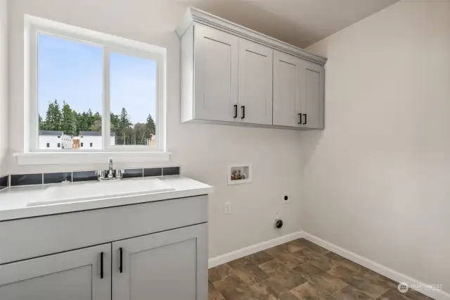 Laundry Room with Upper cabinets and laundry sink