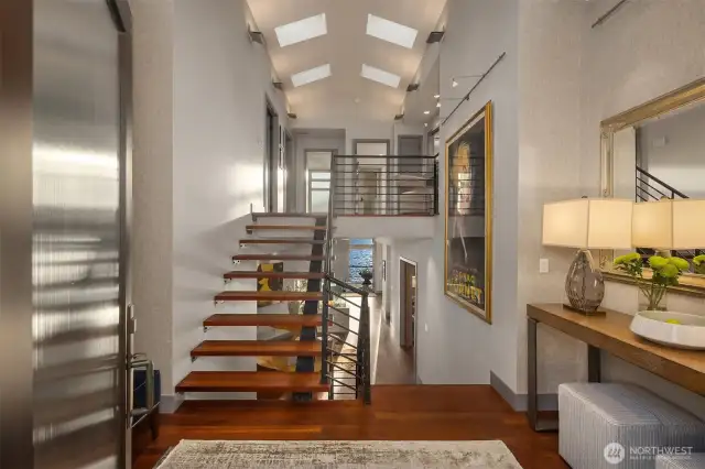 Structural steel floating staircase, exotic Brazilian natural wood floors and species wood millwork.