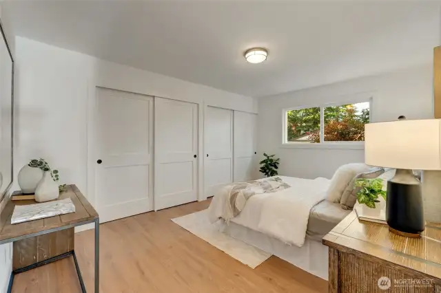 The primary suite features tons of space with two spacious closets complete with custom closet organizers to maximize storage and space. New flooring, attached full bathroom and new triple pane windows.