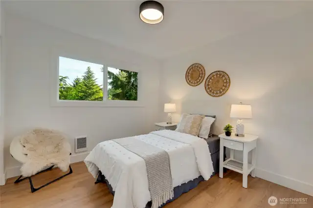 the 3rd bedroom offers the same stunning features as the rest of the newly renovated condo with new flooring, window, doors, closet with custom organizers and gorgeous lighting above!