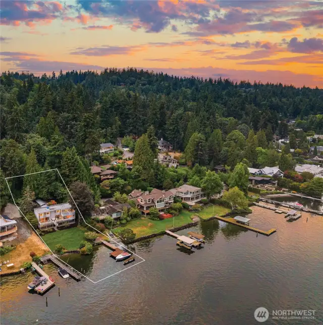 This exceptional waterfront home boasts 85' of prime lake frontage on a sprawling 0.58-acre lot. The rectangular lines are for demonstration purposes only and do not represent the actual property lines. The neighbor's renovation is near completion.