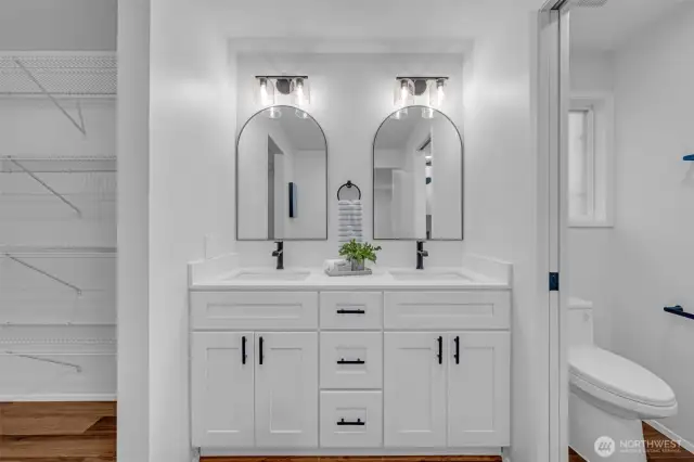 Completely remodeled primary bathroom with double vanity and walk-in shower