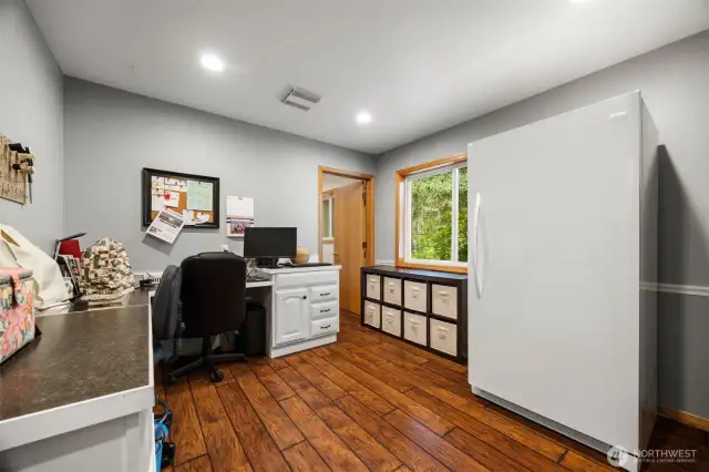 There is an office which was a hair salon not that long ago. This has laminate flooring and a 1/2 bath.