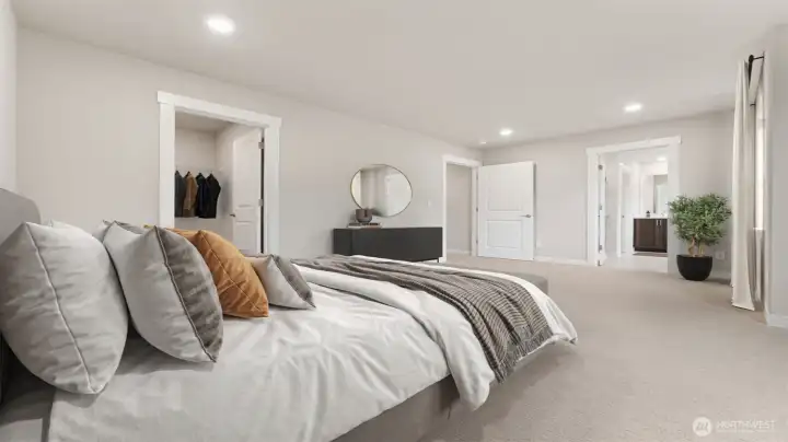 Primary bedroom with 5-piece attached bathroom and walk-in closet. Actual home is under construction and materials, colors, and finishes will vary. See site agent for details.