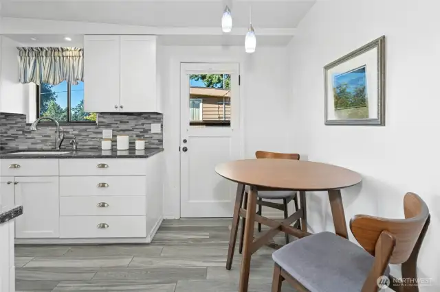 Keep the breakfast area or reconfigure the kitchen and add more cabinetry. Door leads to exterior walkway and carport.