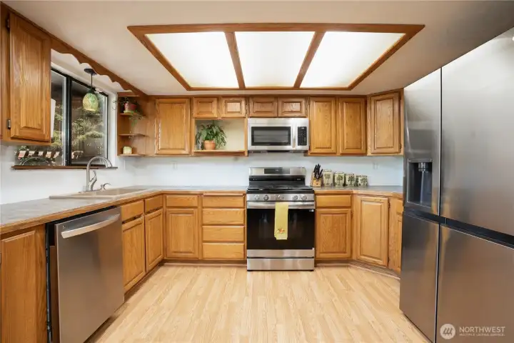 Kitchen with newer SS appliances - range, fridge & microwave