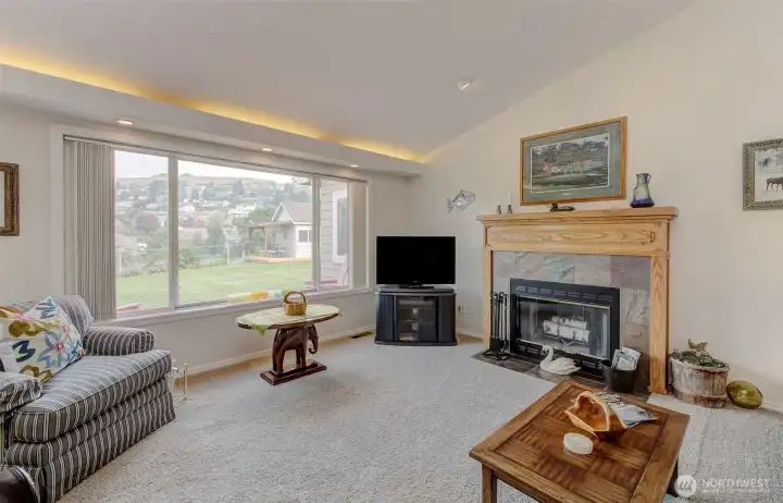 Spacious Living Room features vaulted ceiling, backlighting, large fireplace and picture window to the VIEW!