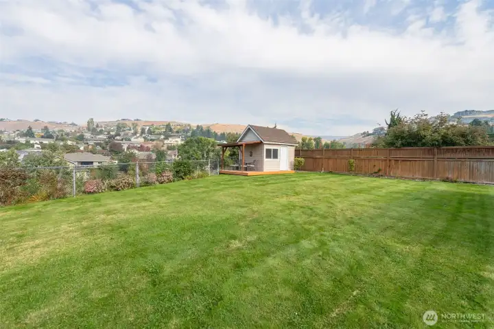 Flat, spacious back yard features a hobby cottage with it's own covered porch for gazing over the canyon!