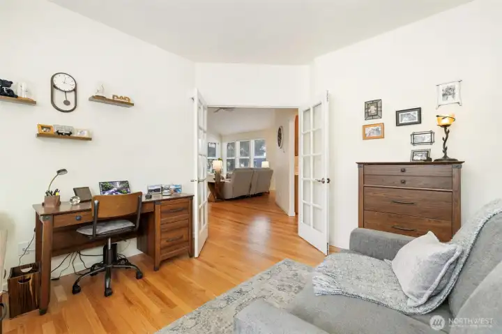 Bright and roomy office/den with French doors, ideal for productivity or relaxation.