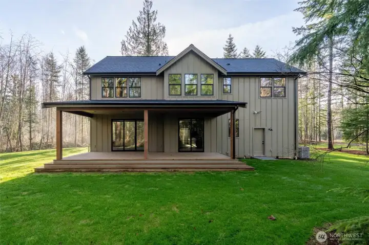 A massive covered deck off the back of the house, perfect for listening to the birds in the trees all year long.