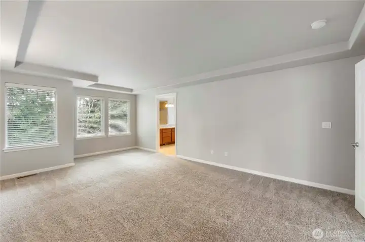 Primary bedroom with double doors , Coffered, Ceilings And Tiled in 5 Piece Oasis Bathroom