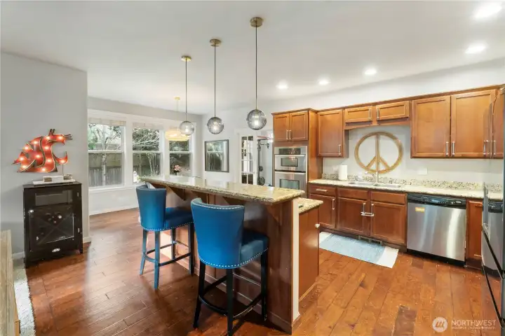Open Great Room Kitchen  with Breakfast Bar Seating . Hardwoods and Granite Counter Tops
