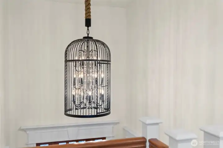 You'll be greeted by this gorgeous creative chandelier as you enter this special home.  Towering over the foyer and staircase its serves as an inviting anchor.