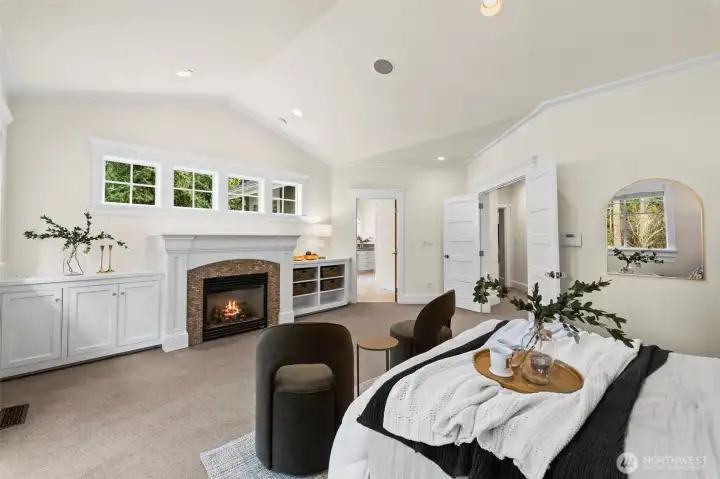 The vaulted primary retreat offers a peaceful "stay awhile" atmosphere, complete with a private fireplace and bespoke built-ins. Dual doors lead to a private deck for morning coffee overlooking the 1.4-acre grounds.