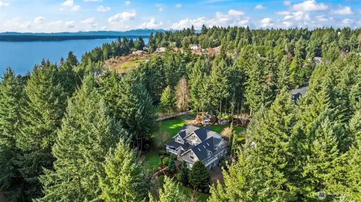 Nestled in the evergreens just a short walk to the beach, this estate has everything you've dreamed of and more. It's calling you HOME today!