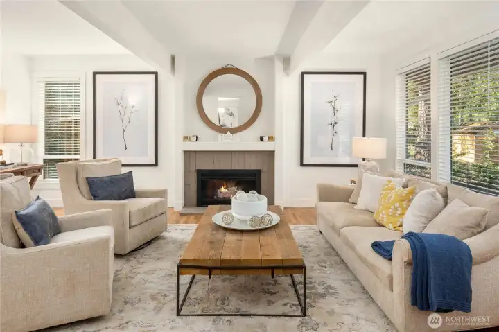 The living room offers clean architectural details from the fireplace to open beams.