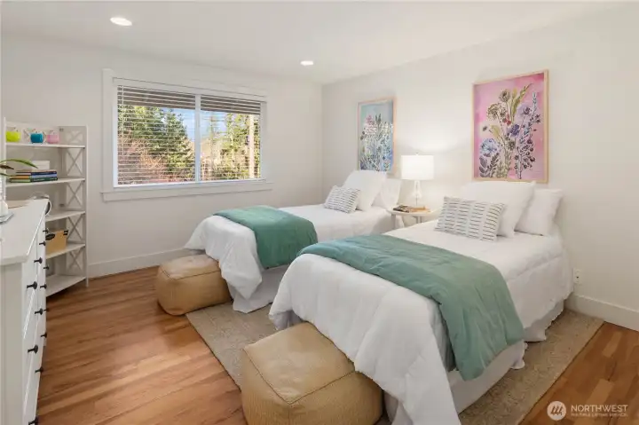 Spacious bedrooms with hardwood floors.