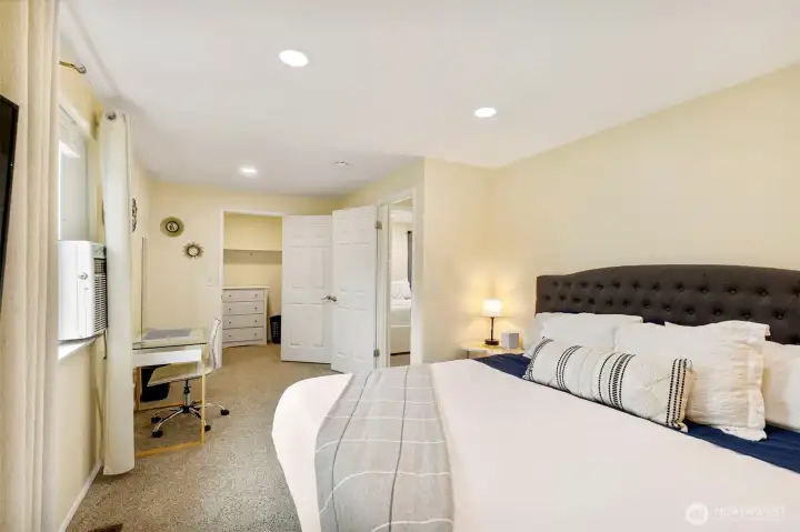 Primary bedroom with a walk-in closet.