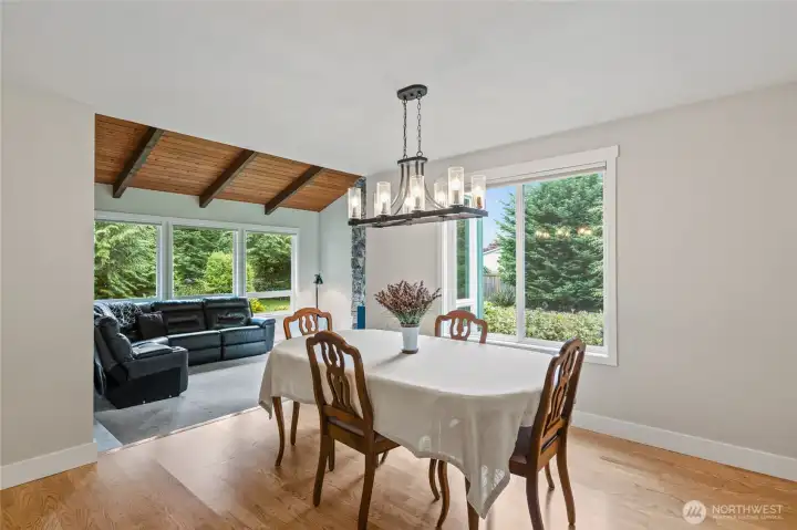 Pretty light fixture over dining table and more natural light.