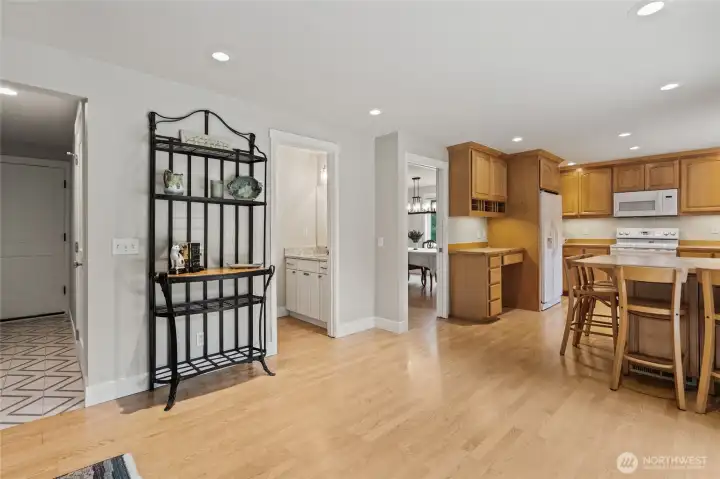 Half bath conveniently located between kitchen and family rooms. Hall to laundry and garage.