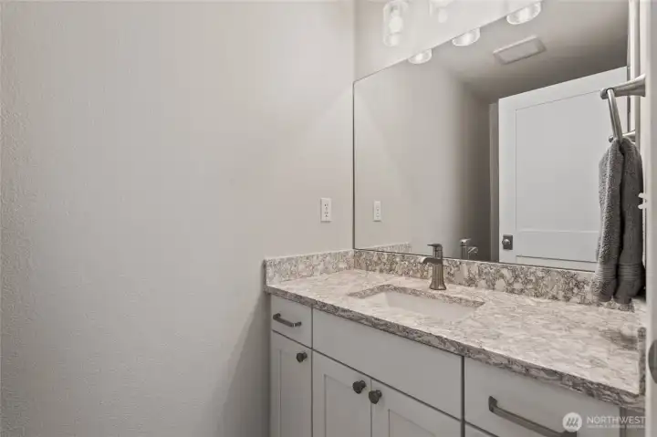 Updated half bath with stone counter.