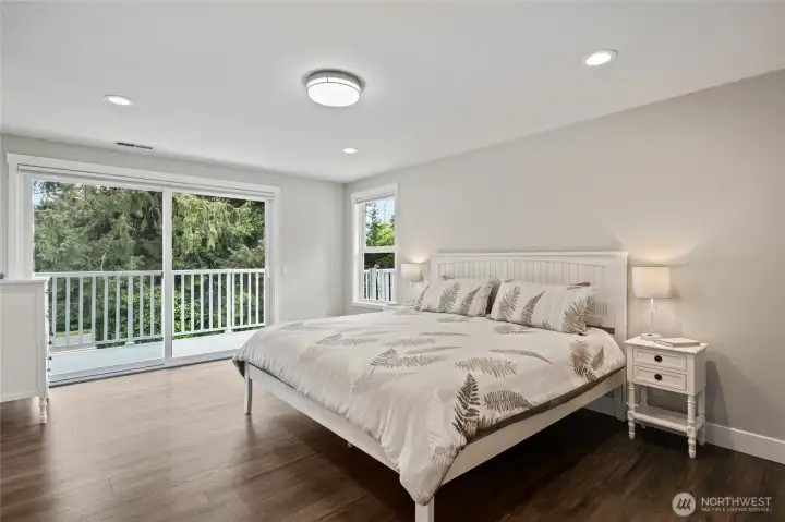 Large primary bedroom with sliders to deck.