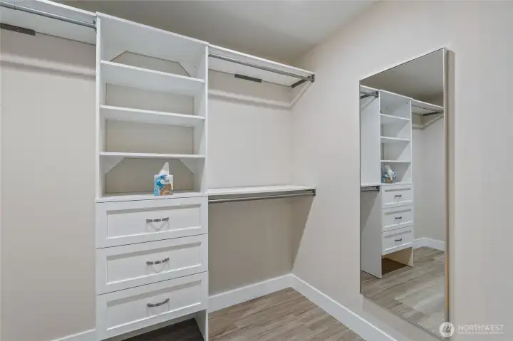 Walk in closet off primary bath with convenient built-ins.