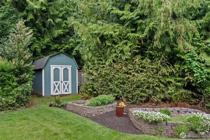 Storage shed and raised beds in the yard for your enjoyment.