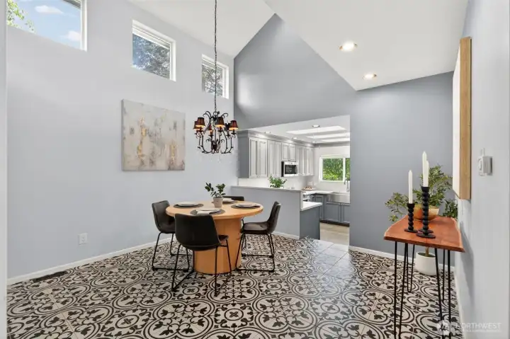 The formal living room bathed in natural light, showcasing the home's flowing open layout