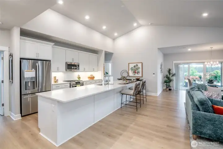 The spacious kitchen is truly the heart of the home, featuring an oversized island, quartz countertops, and plenty of room for gathering and entertaining.