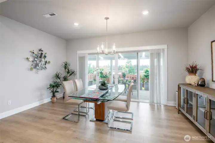 The dining room is perfectly situation to enjoy the light shining in through the large sliding doors.