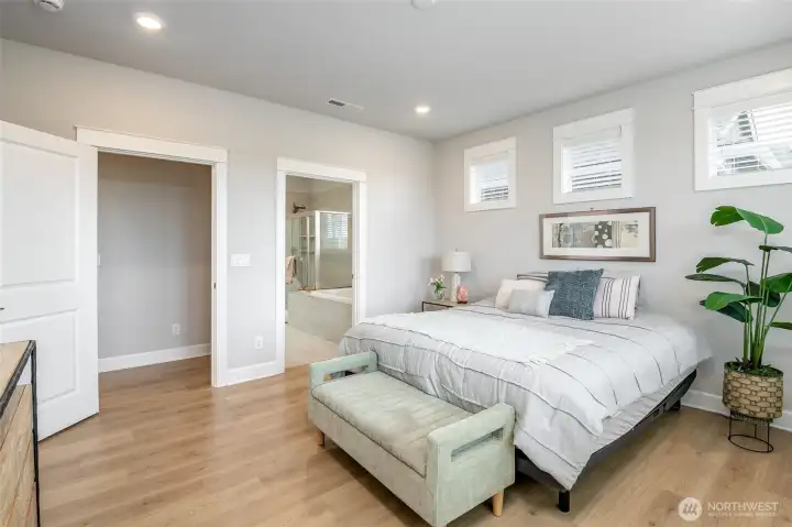 The primary suite is full of natural light and features a walk-in closet and 5 piece bathroom.