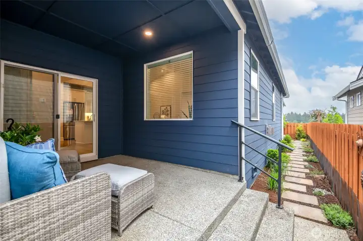 The side patio had pretty pavers leading to the back of this fully-fenced yard.