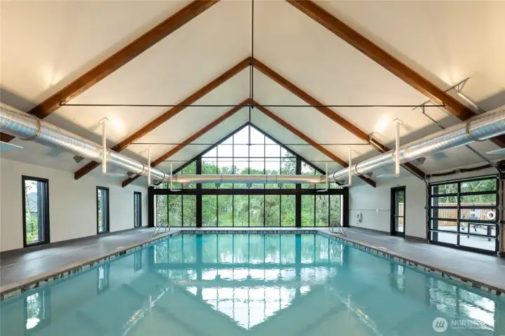 Enjoy this gorgeous pool, with garage doors that open up in the summer.