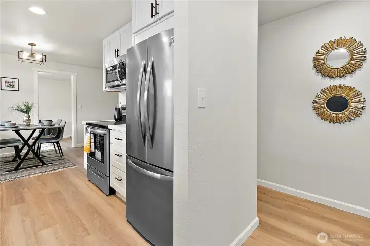 Completely remodeled home with white kitchen and stainless steel appliances.