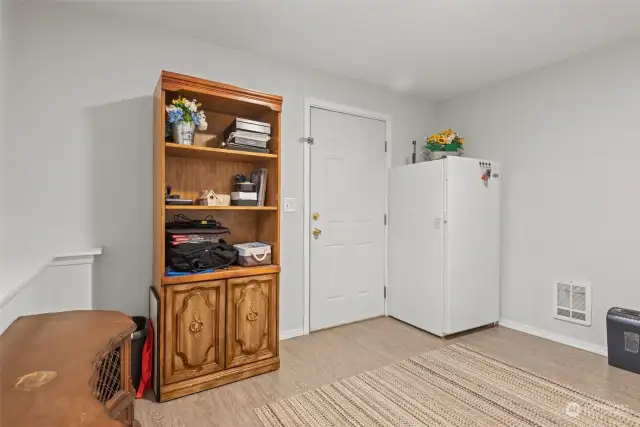 Main floor bedroom, currently used as an entry area and storage space