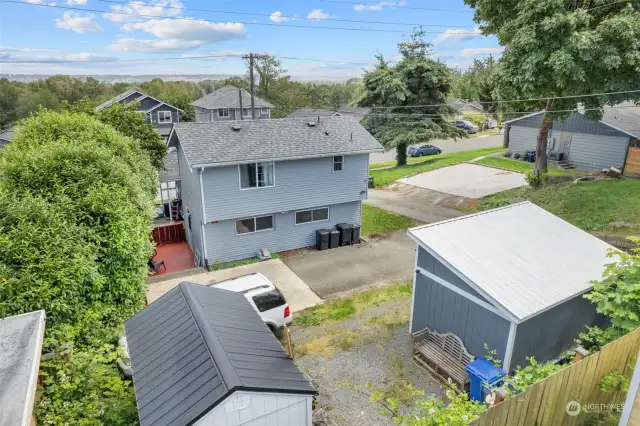 Aerial view shows the set up of the home, storage shed, and new shed that can easily be used as an extra room -- could be an office or studio to rent out?