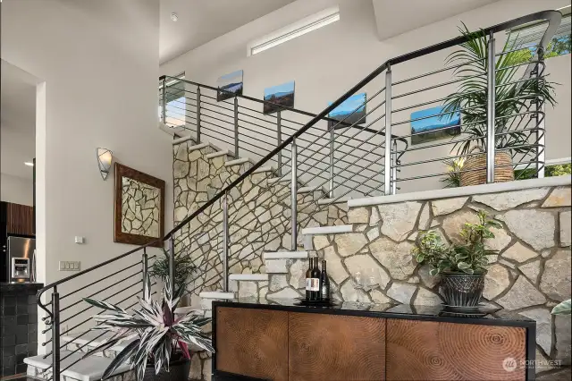 Hand cut lime stone stair case. Pictures on the stairway wall are of the view at each season.