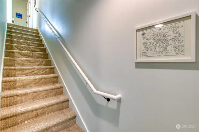 The stairwell to the upper levels is accessible directly from the mudroom.