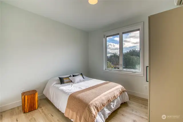 The south bedroom is filled with natural light and offers views of the water.