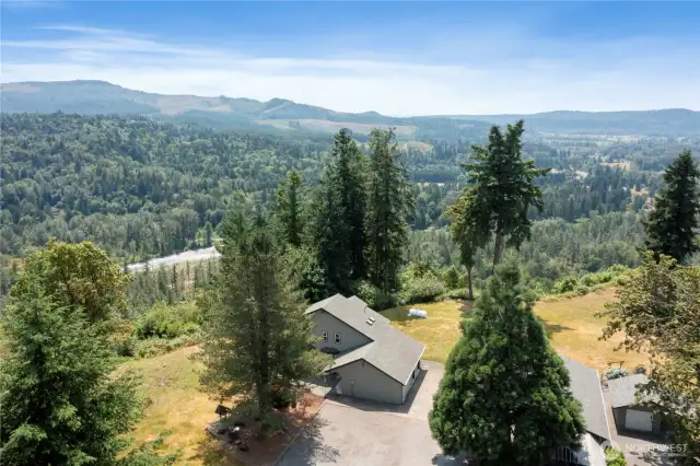 Drone picture of home facing west with territorial view of Orting Valley, and Carbon River below property.