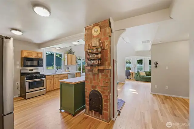 Spacious kitchen recently updated with the focal point brick chimney.