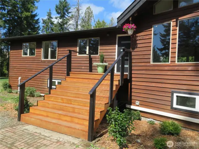 Wide stairway leads to the upper level - stylish finishes and architectrual inrigues.
