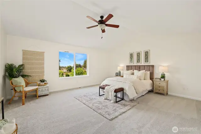 Spacious primary bedroom with vaulted ceilings