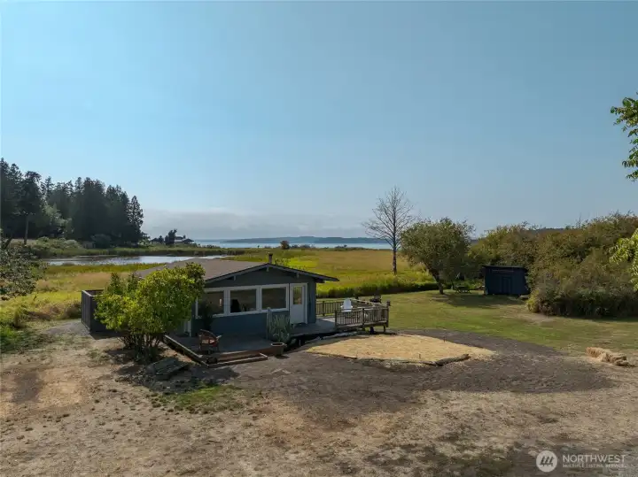Flat Point Cottage---Classic Lopez Living.  The front yard is a bit of a mess as the yard is under restoration due to a new septic system being just installed.  But just wait, soon the grass will be up and all will look great again.